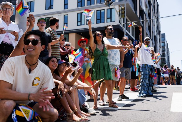People cheer and wave pride flags during the San Diego Pride parade in San Diego on Saturday, July 18, 2026. (Kristian Carreon / The San Diego Union-Tribune)