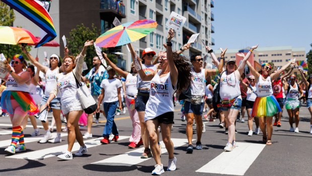 Participants with the YMCA cheer and dance during the San Diego Pride parade in San Diego on Saturday, July 18, 2026. (Kristian Carreon / The San Diego Union-Tribune)