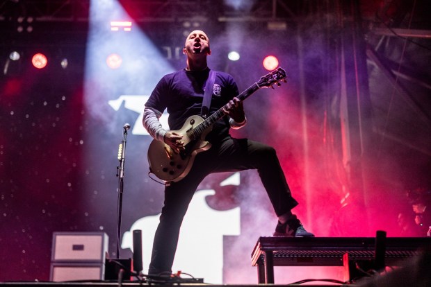 Jeff Stinco of Simple Plan performs during Sonic Temple Art and Music Festival. Simple Plan will perform at Harrah's on Sunday. (Photo by Amy Harris/Invision/AP)