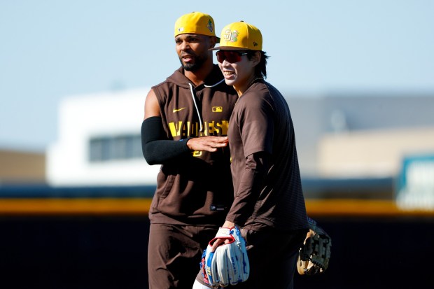 Sung-Mun Song #24 and Xander Bogaerts #2 of the San Diego Padres hug during spring training workouts at the Peoria Sports Complex on Saturday, Feb. 14, 2026 in Peoria, Ariz. (Meg McLaughlin / The San Diego Union-Tribune)
