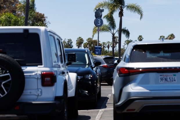 A koala-themed row sign with a paid parking sign in the parking lot of the San Diego Zoo in San Diego on Thursday, July 23, 2026. (Kristian Carreon / The San Diego Union-Tribune)