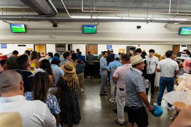 Del Mar, CA - Attendees wait in line to place bets during Opening Day at the Del Mar Racetrack on Friday, July 17, 2026, in Del Mar, CA. (Brandon Pollard / The San Diego Union-Tribune)