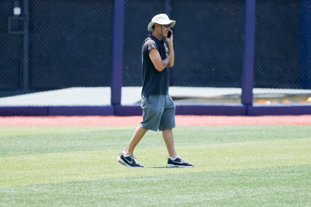 San Diego Padres president of baseball operations A.J. Preller talks on the phone in the outfield before Game 2 of the MLB World Tour Mexico City Series at Alfredo Harp Helu Stadium on Sunday, April 26, 2026 in Mexico City, Mexico. (Meg McLaughlin / The San Diego Union-Tribune)