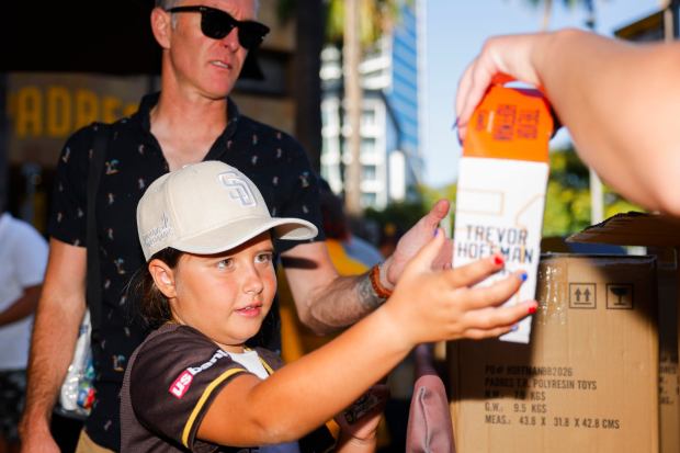 Madeleine Giraud, 8, receives a Trevor Hoffman bobblehead before the San Diego Padres game against the Arizona Diamondbacks at Petco Park on Wednesday, July 8, 2026 in San Diego, California. (Meg McLaughlin / The San Diego Union-Tribune)