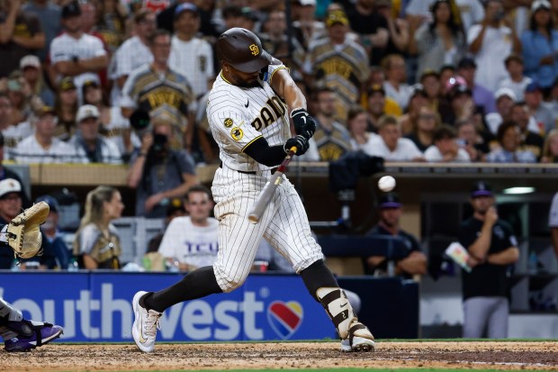 Xander Bogaerts of the San Diego Padres hits a walk-off sacrifice fly against the Colorado Rockies during the ninth inning at Petco Park on Tuesday, July 28, 2026 in San Diego, California. (Meg McLaughlin / The San Diego Union-Tribune)