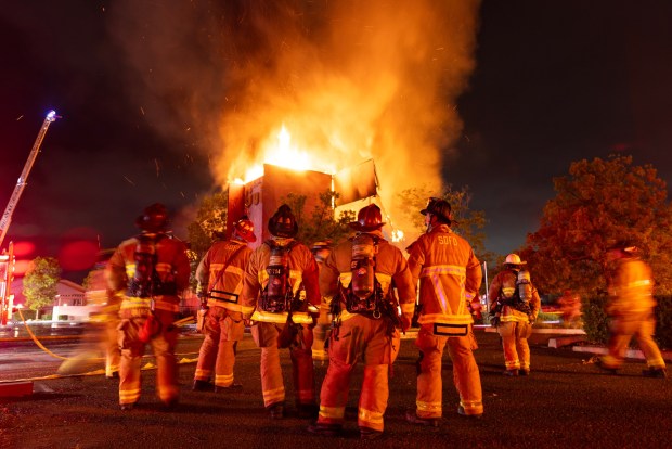 San Diego, CA - Crews work to battle a three alarm fire that broke out early on Sunday, July 5, 2026, in an abandoned building in the Serra Mesa neighborhood in San Diego, CA. Crews moved from an offensive position, into a defensive one as the building became fully engulfed and started collapsing. (Luke Johnson / The San Diego Union-Tribune)