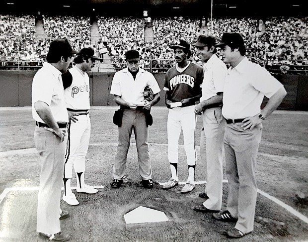 Coaches from the Reno Padres and Redwood Pioneers confer with umpires prior to the July 4, 1981 game betweent he two minor-league teams at San Diego Jack Murphy Stadium. (Andy Strasberg)