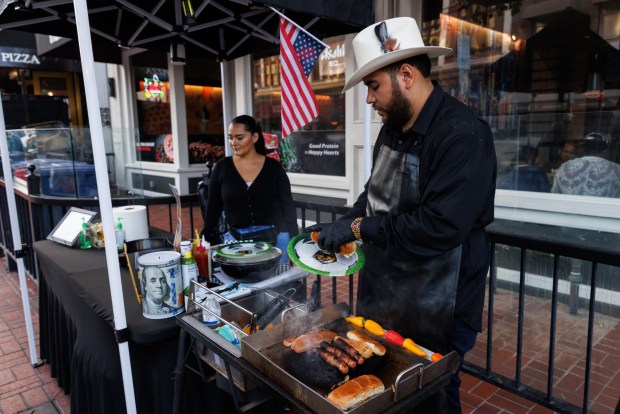 A vendor sells hot dogs in Gaslamp Quarter in downtown Diego on Friday, July 3, 2026. (Kristian Carreon / The San Diego Union-Tribune)