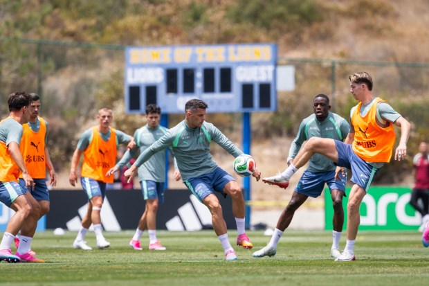 Switzerland's Granit Xhaka, center, and Cedric Itten, right, battle for the ball during a June 3 training session at the San Diego Jewish Academy. (Peter Klaunzer/Keystone via AP)