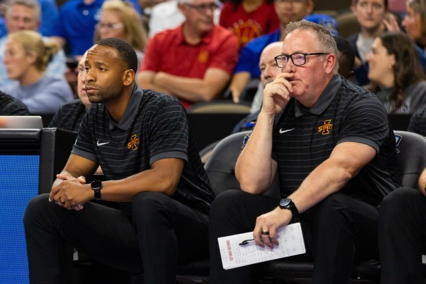 Iowa State assistant coaches JR Blount and Kyle Green watch from the bench during the second half of an NCAA college basketball exhibition game against Creighton, Sunday, Oct. 19, 2025, in Omaha, Neb. (AP Photo/Bonnie Ryan)