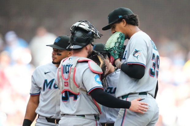 Miami Marlins catcher Liam Hicks, front left, talks with pitcher Eury Pérez, right, on the mound during the sixth inning of a baseball game against the Milwaukee Brewers, Sunday, July 19, 2026, in Milwaukee. (AP Photo/Kayla Wolf)