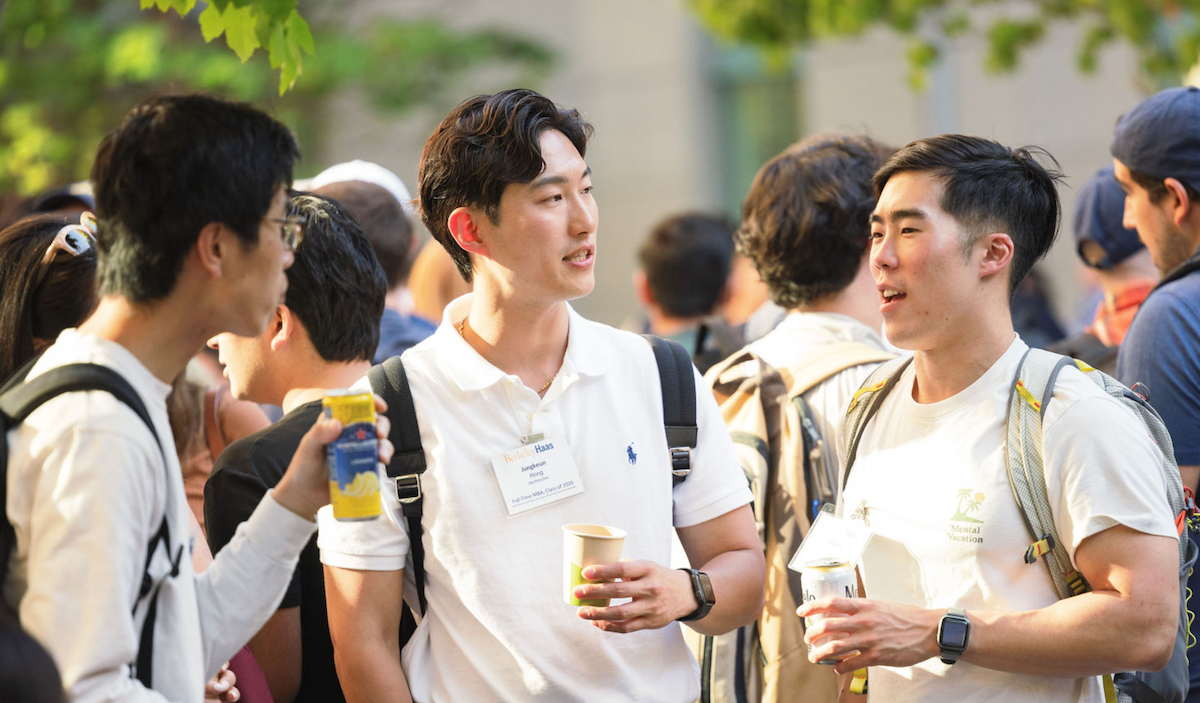 three men talking all wearing white shirts and backpacks