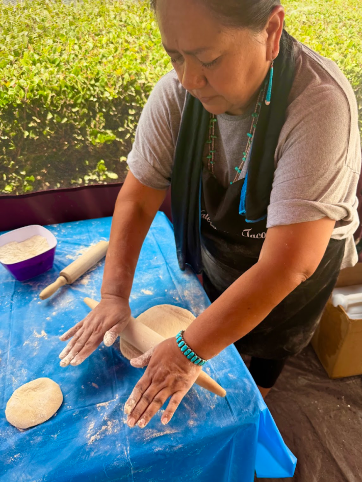 a woman rolls out dough