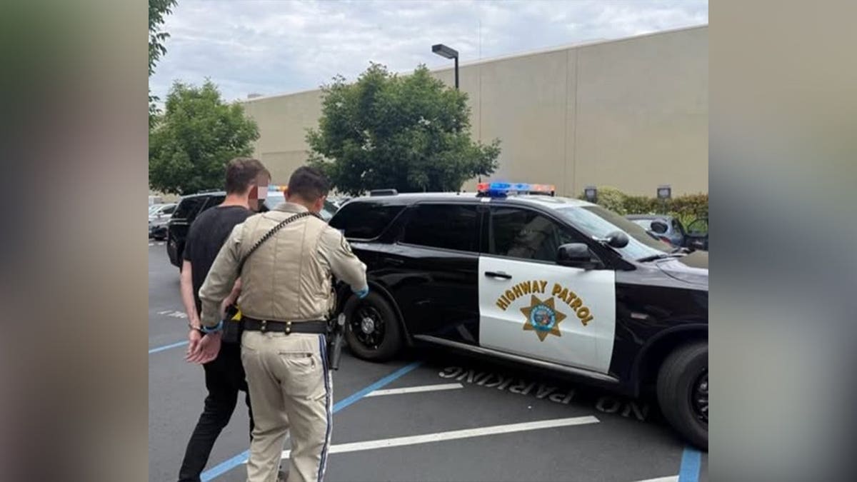 California Highway Patrol officers escort Zachary Chernicky in handcuffs following his arrest.