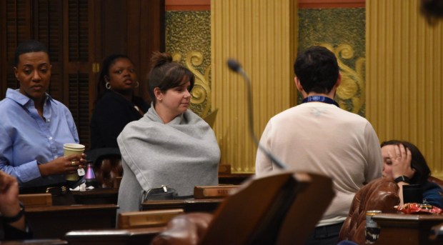 Democratic members of the Michigan House discuss on the House floor while they await votes on the state budget. July 3, 2026. (Katherine Dailey/Michigan Advance)