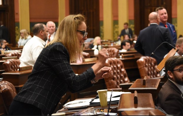 Rep. Donni Steele (R-Orion Twp.) talks with staff on the House floor while representatives await votes on the state budget. July 3, 2026. (Katherine Dailey/Michigan Advance)