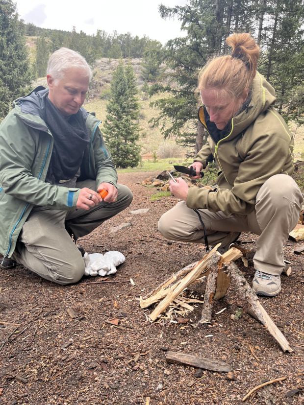 Clients Scott and Dyanna Rezac prepare to build a fire. {Provided by The Survival University)