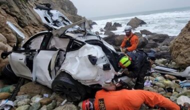 Emergency personnel respond to a vehicle over the side of Highway 1 on Jan. 1, 2023, in San Mateo County, Calif.
