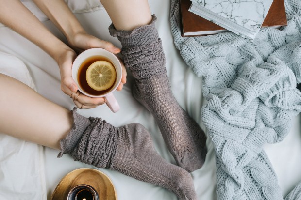 Wearing socks to bed is one way to keep your body cooler while sleeping. By warming the feet, blood vessels under the skin dilate, letting warm blood reach the surface, causing body temperature to drop. That's what signals the brain to get ready for sleep. Just be sure not to offset the gain and remember to drink only nonalcoholic, noncaffeinated warm beverages before bed. (Photo courtesy of Metro Editorial Services)