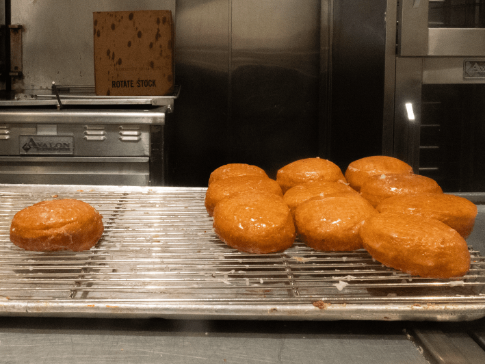 freshly made donuts in an inudstrial kitchen
