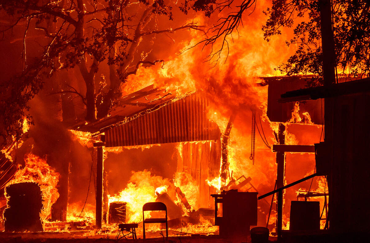 A property burns in the Park Fire near Paynes Creek in Tehama County in 2024.