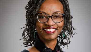 headshot of woman in glasses smiling