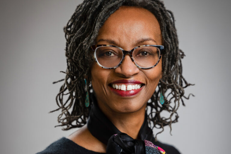 headshot of woman in glasses smiling