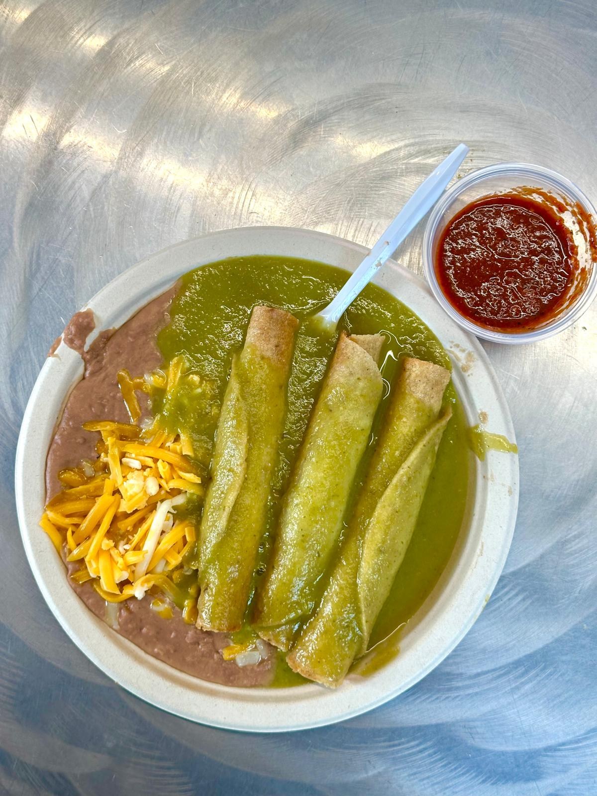Rolled tacos with refried beans and salsa.