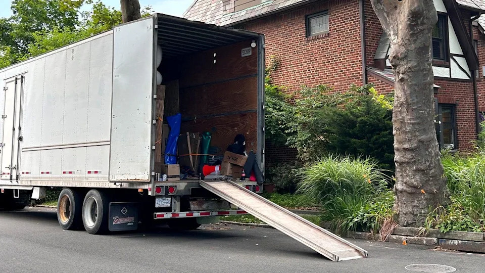 moving truck with ramp outside home