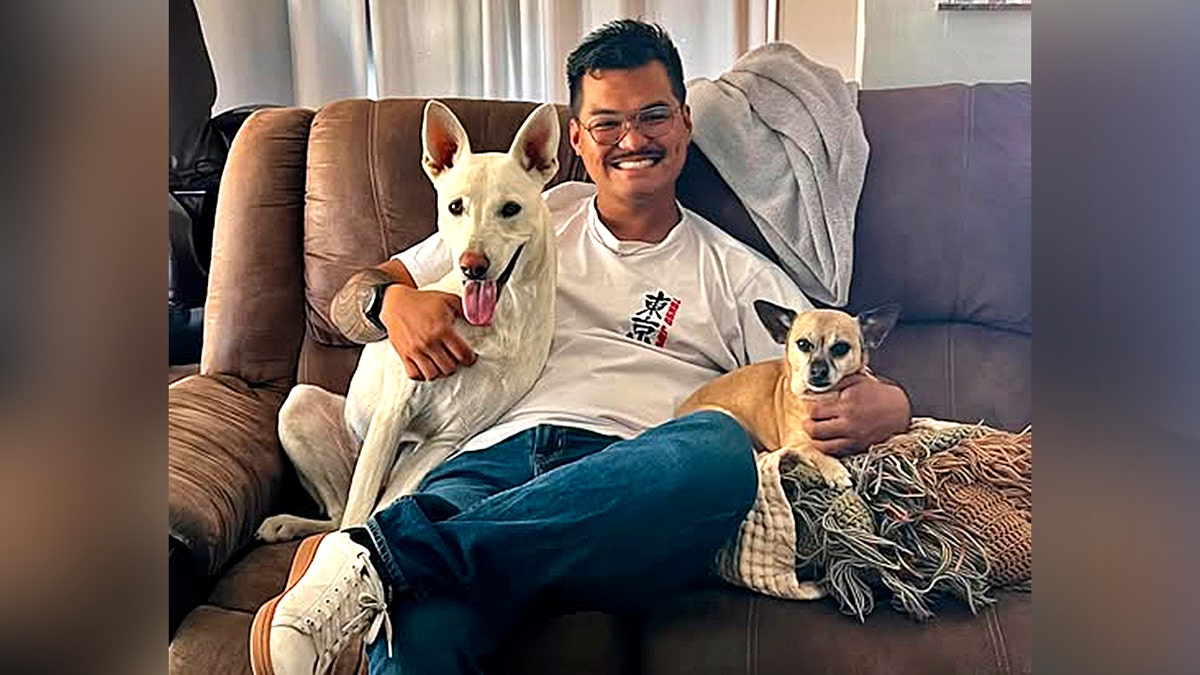 Man sitting with two dogs