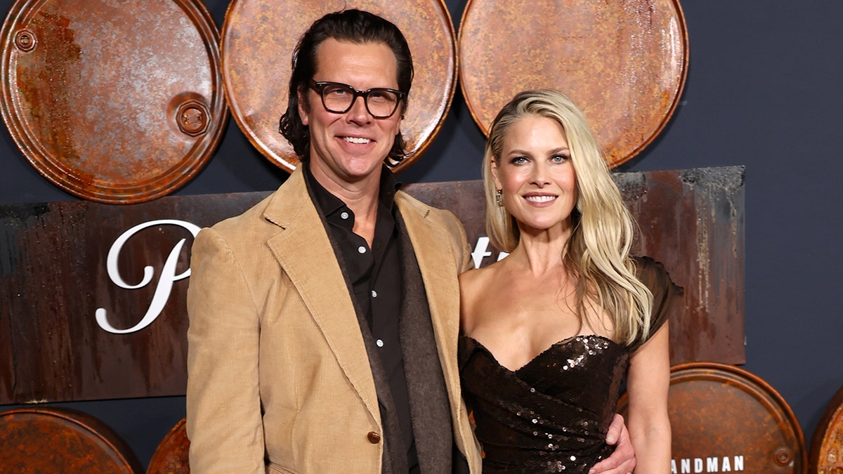 Ali Larter and Hayes MacArthur standing together at the Los Angeles premiere of Landman