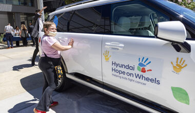 Alizah Martinez puts her painted hands on the white Hyundai Palisade