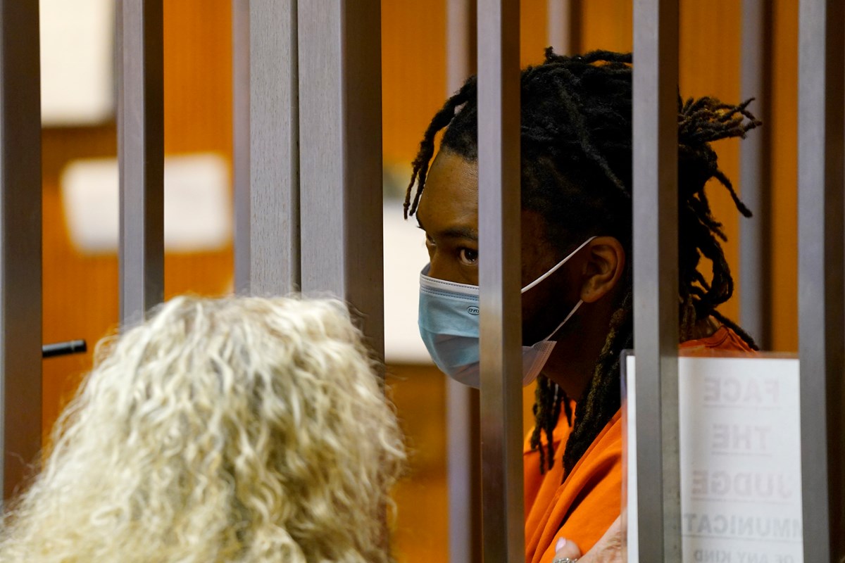 Dandrae Martin talks with attorney Linda Parisi at his first court appearance in Sacramento County Superior Court, in Sacramento, Calif., Tuesday, April 5, 2022.