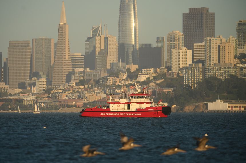 A San Francisco Fire Department vessel passes the city skyline while searching for missing victims after a boat accident Tuesday near Alcatraz Island off San Francisco.