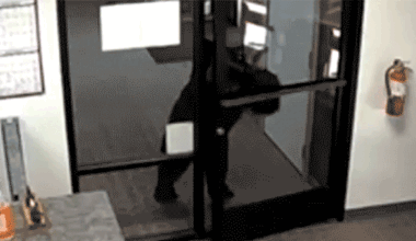 Black bear pushes open the front door of the Crestline Village Water District office