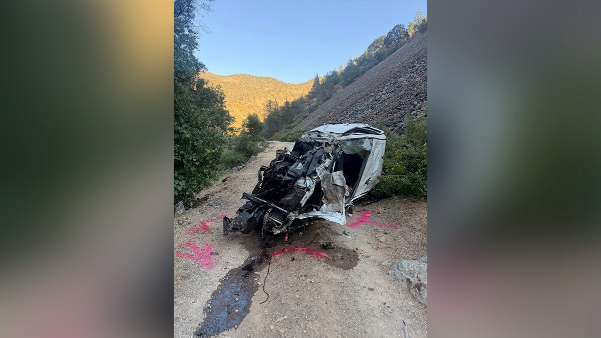 Mangled white pickup truck wreckage