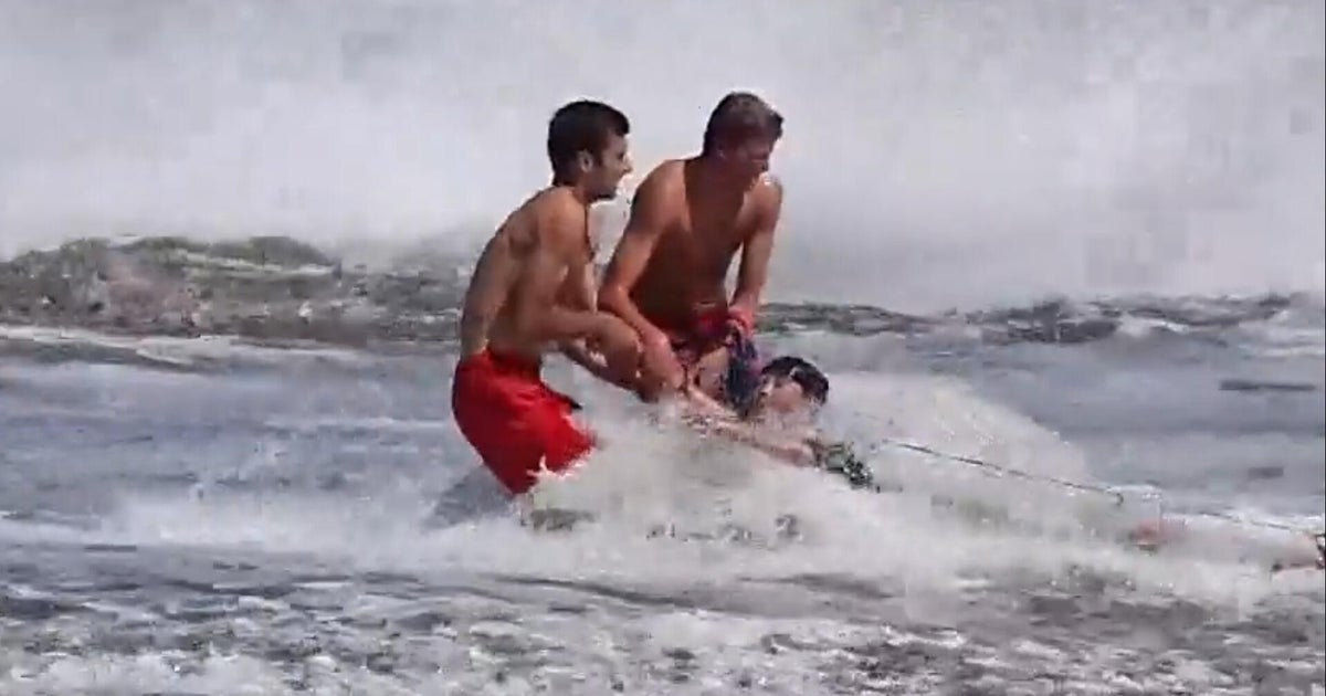 Pair of lifeguards keep young swimmer from being swept out to sea in California