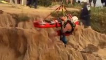 Emergency personnel used a crane to hoist a person during a cliff rescue on July 28, 2026. (Credit: hi_tide_619)