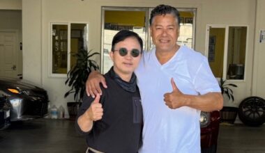 Enoch Shin, left, operator of an auto body shop on International Boulevard in Oakland, with City Councilmember Ken Houston, right, at the Oakland City Council meeting on Tuesday.