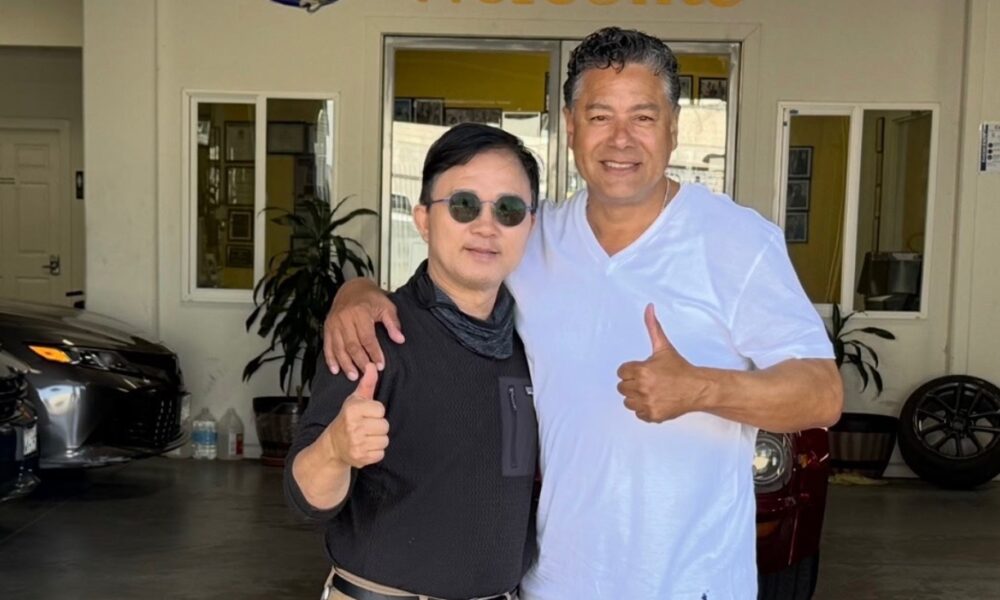 Enoch Shin, left, operator of an auto body shop on International Boulevard in Oakland, with City Councilmember Ken Houston, right, at the Oakland City Council meeting on Tuesday.