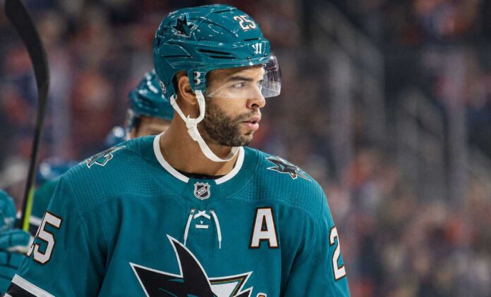 Darnell Nurse wearing a San Jose Sharks jersey and helmet amid Edmonton Oilers trade rumors linking him to San Jose