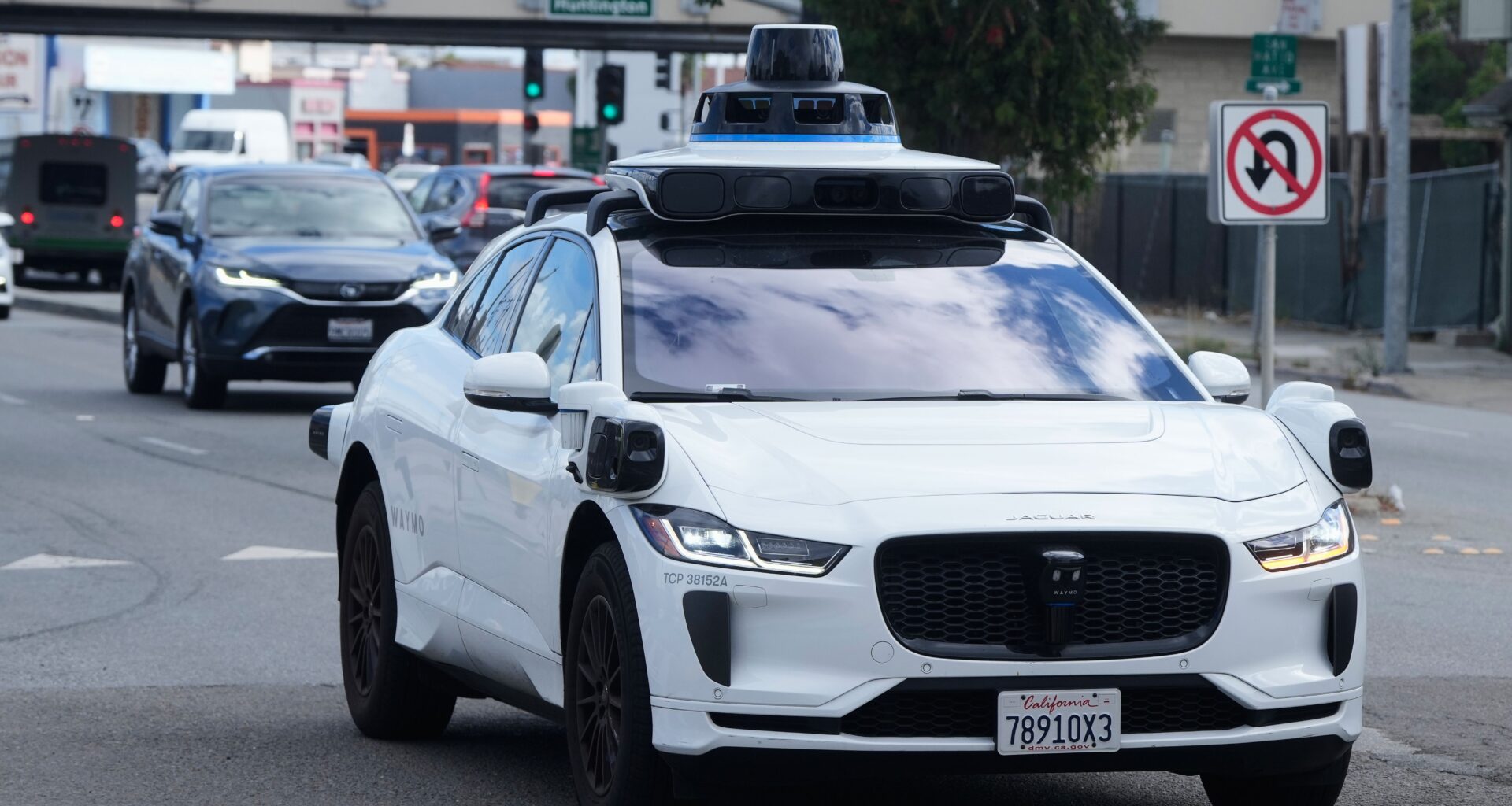 FILE - A Waymo vehicle drives past a No U-Turn sign in San Bruno, Calif., Tuesday, Sept. 30, 2025. (AP Photo/Jeff Chiu, File)