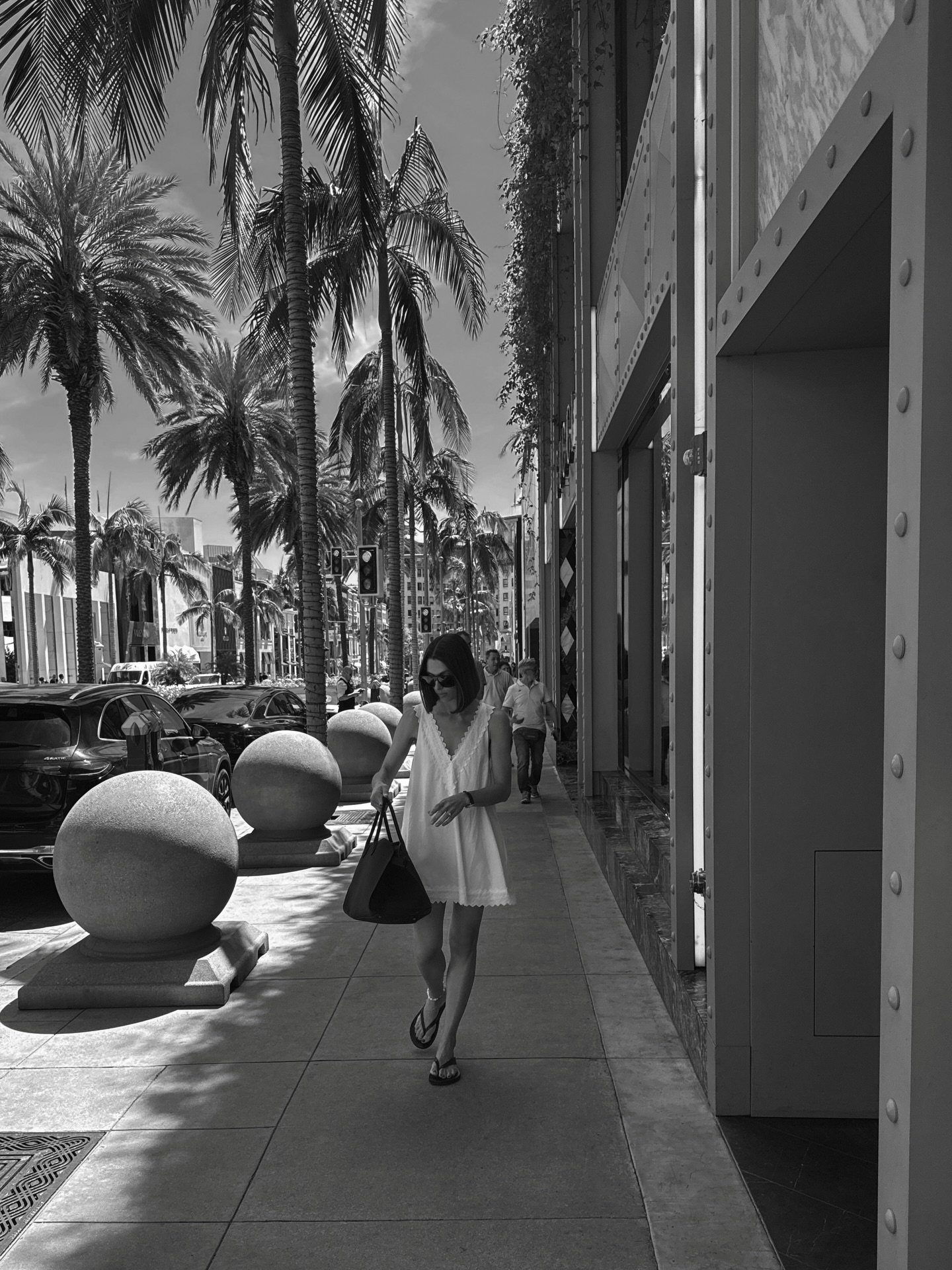 Jaime in white mini dress and flip-flops