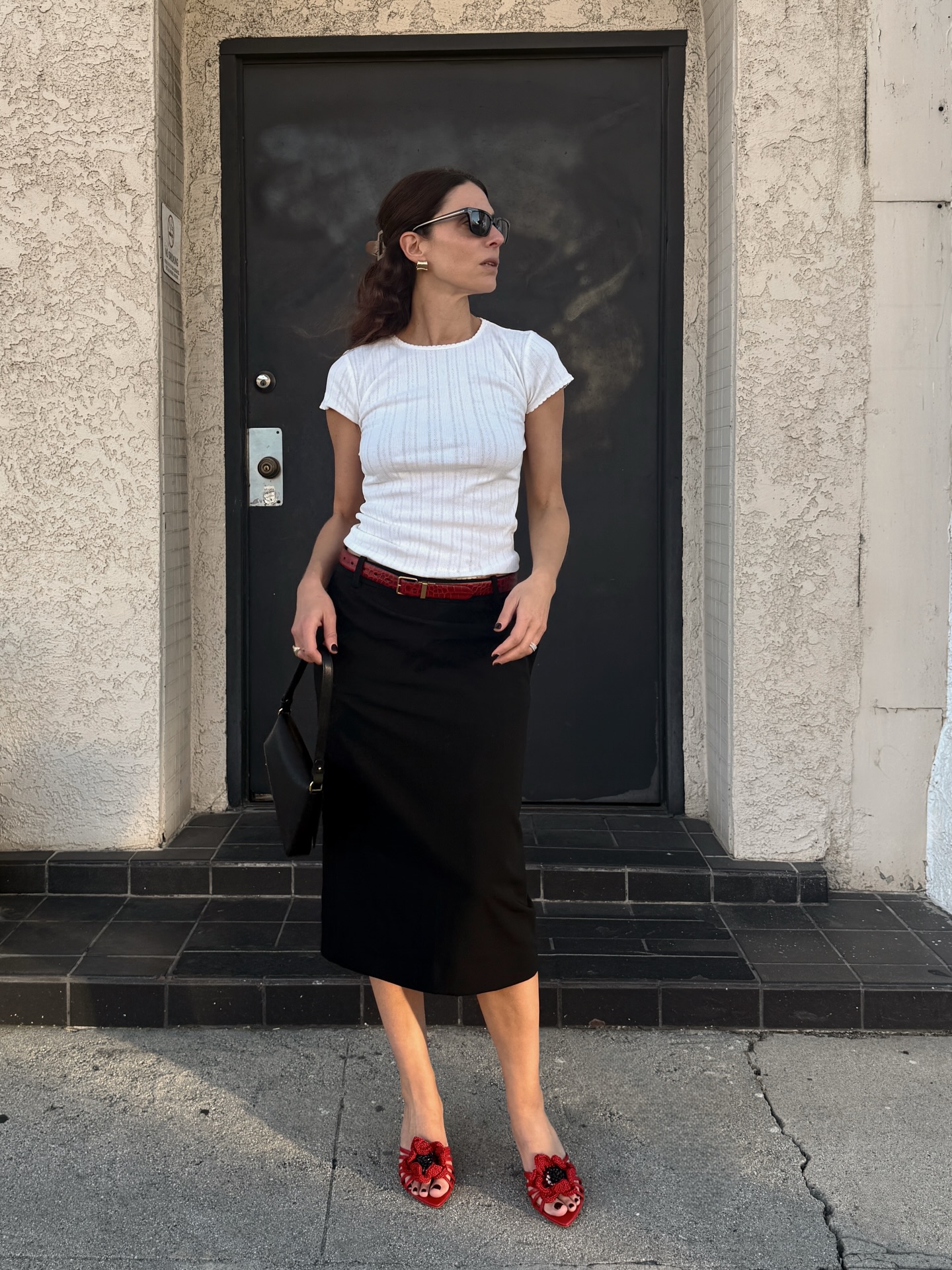 Jen in white tee and black skirt