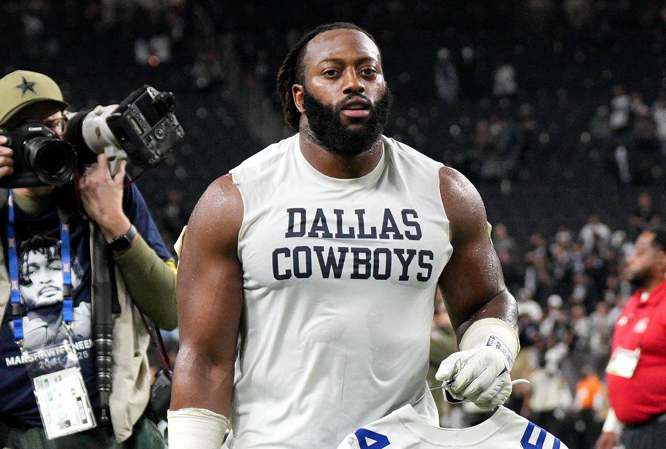 LAS VEGAS, NEVADA - NOVEMBER 17: Osa Odighizuwa #97 of the Dallas Cowboys holds the jersey of Marshawn Kneeland after the game against the Las Vegas Raiders at Allegiant Stadium on November 17, 2025 in Las Vegas, Nevada. (Photo by Candice Ward/Getty Images)