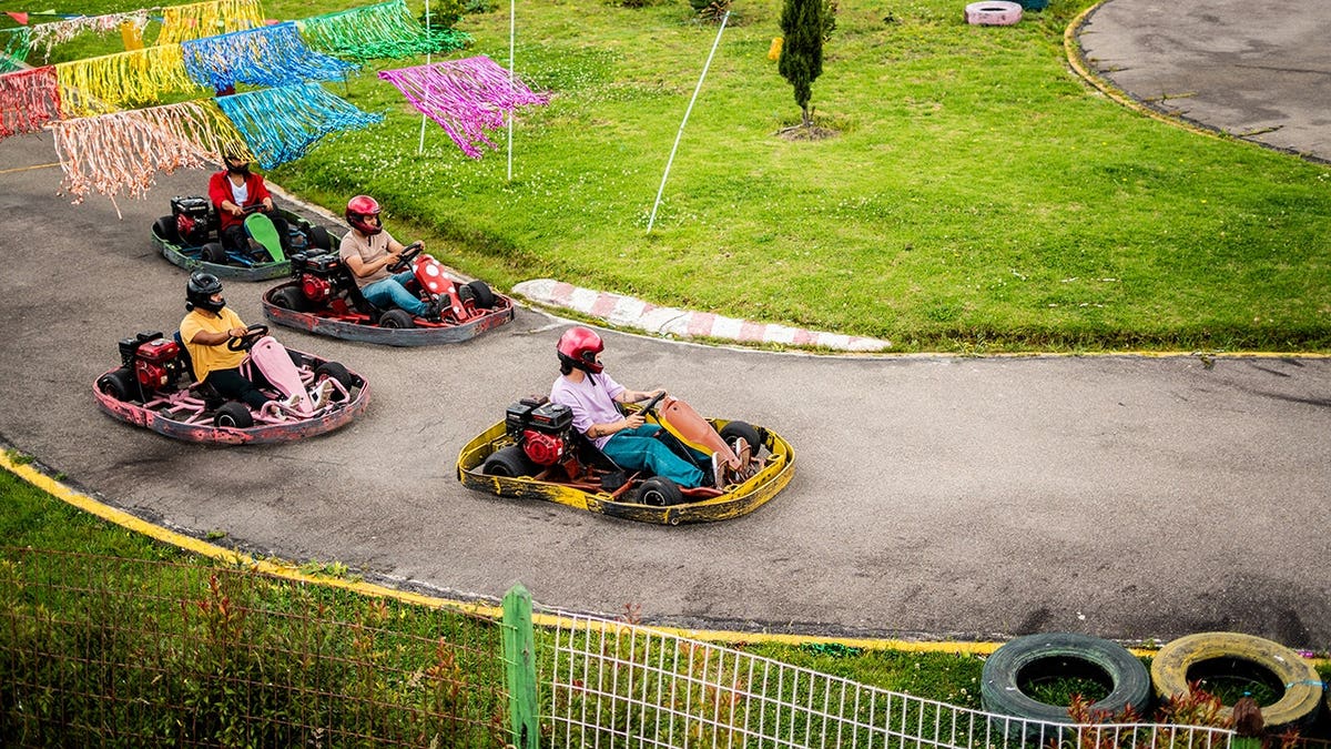 People go-karting on an outdoor track