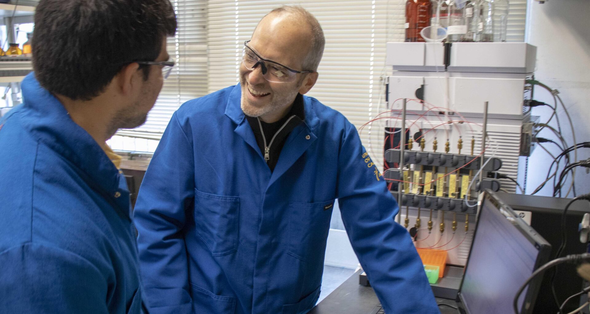 John Hartwig in lab with researcher