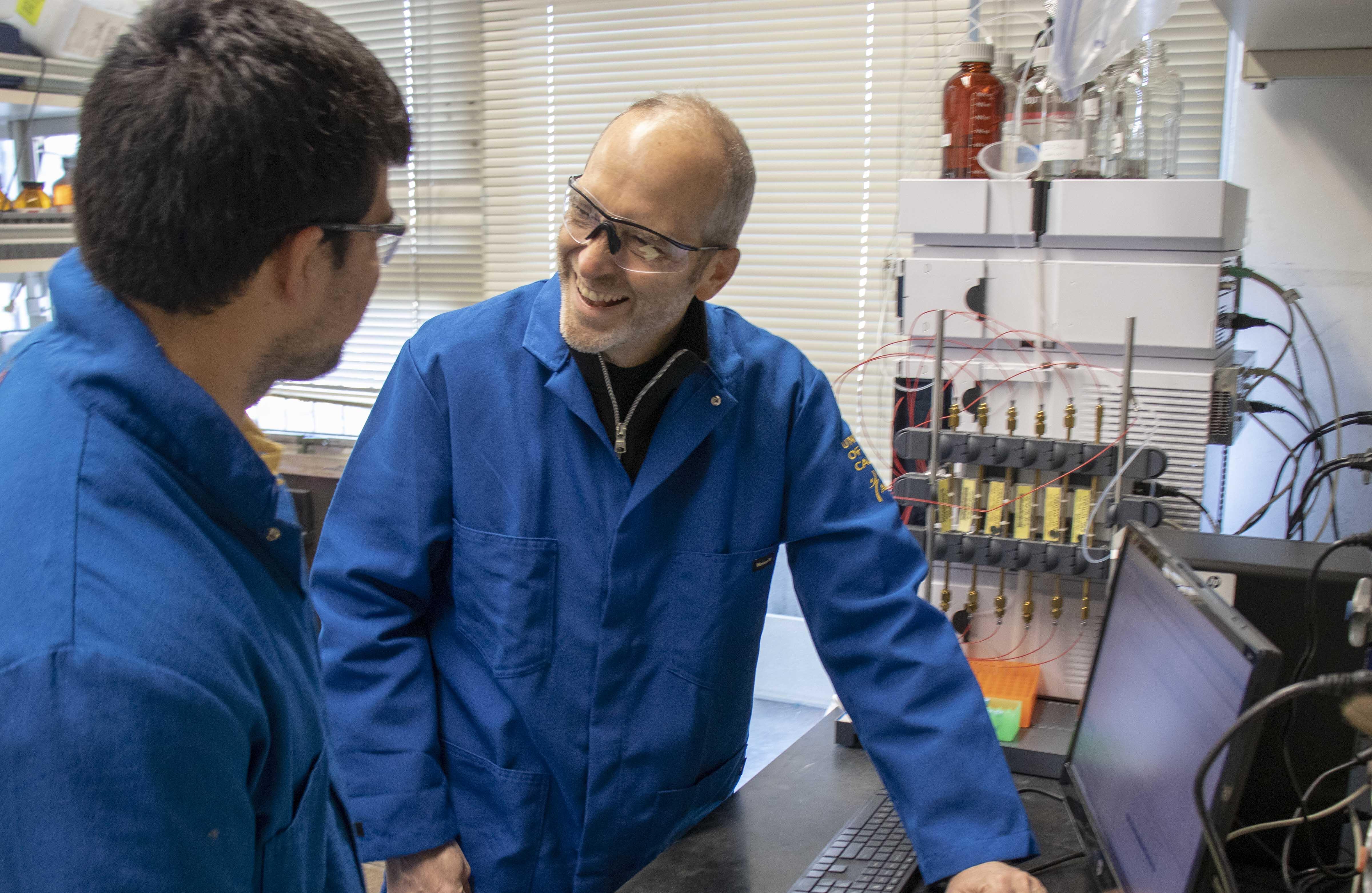 John Hartwig in lab with researcher