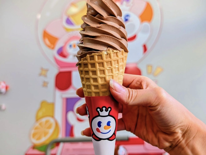 Chocolate soft serve on a waffle cone