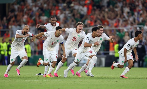 The Moroccan team celebrates after defeating the Netherlands in a penalty shootout in the World Cup round of 32 on Monday night in Mexico. (AP Photo/Sofia Yaker)